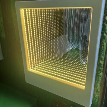 an infinity mirror reflects the colour yellow repeatedly