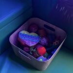 a small wood effect box contains a variety of sensory toys.