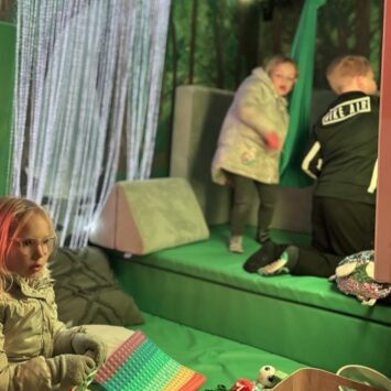 Three children play inside the sensory space