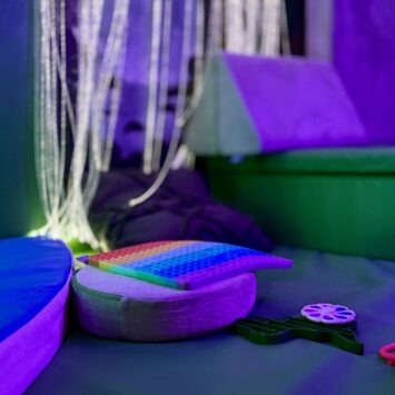 cushions are scattered amongst toys showing the use of the sensory bus