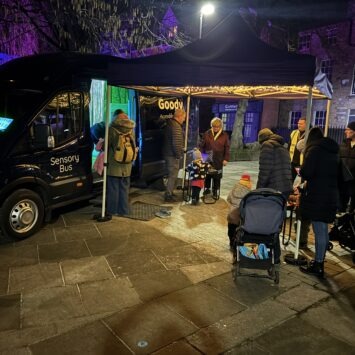 In the night, crowds gather around the mobile sensory space and the additional sensory trays at Rotherham