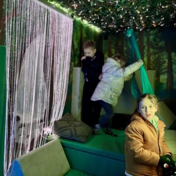 three children play together onboard the mobile sensory space
