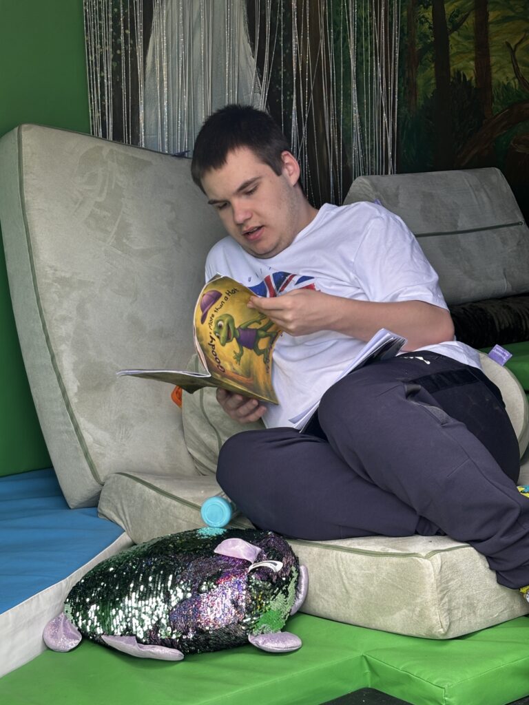 a young adult lays reading Goody: More than a hat
