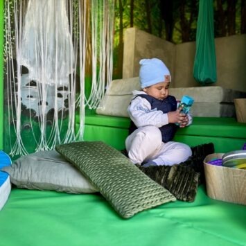 small child holds sensory timer and regulates