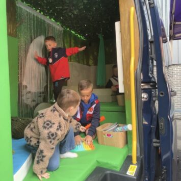 children in Wakefield Trinity Sports tops explore the sensory bus