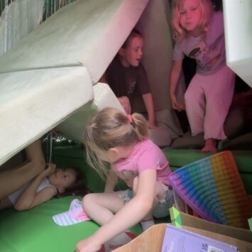 children build multi layer den with the sofa inside the bus to envelop themselves.