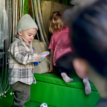 small boy interacts with sensory equipment