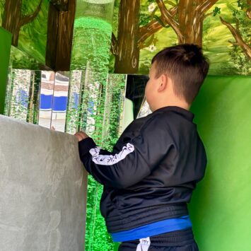 boy watched green bubbles inside the bus
